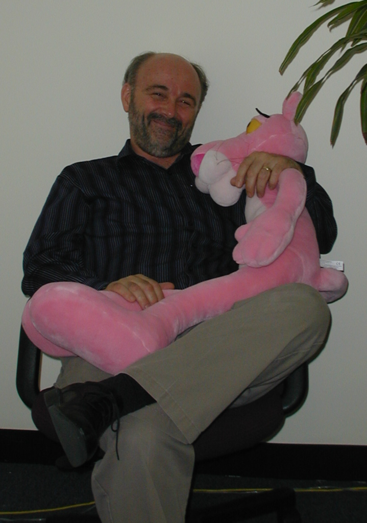 Ed Connelly posing with stuffed animal pink panther